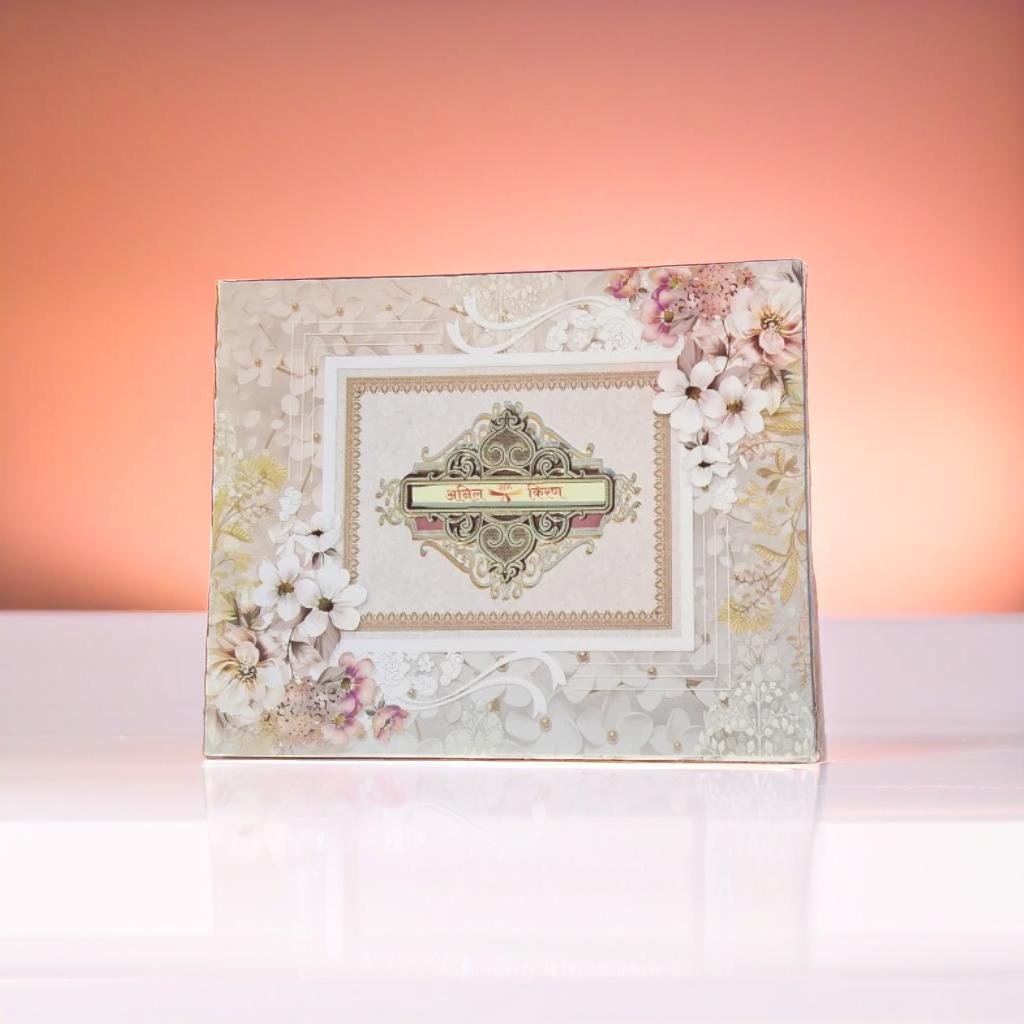 A White And Pink Wedding Card With Floral Designs