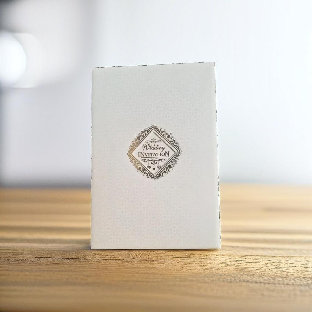 A Laser Cut Card With A Green And White Design On It.