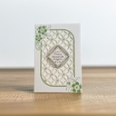 A Laser Cut Card With A Green And White Design On It.