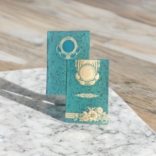 A green wedding card with a silver medallion on it