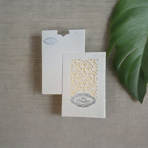 A White Laser Cut wedding card With A Intricate Design On It