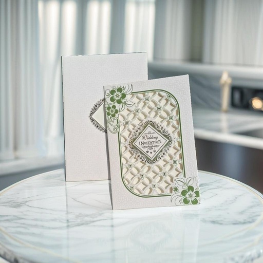 A Laser Cut wedding card With A Green And White Design On It.